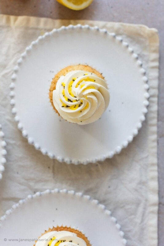 Top down shot of the lemon and poppyseed cupcake on a plate