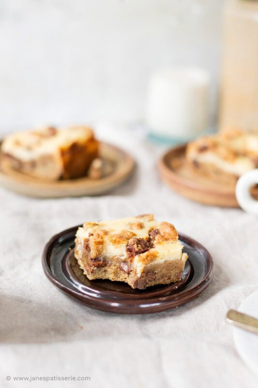 A bite missing from a square of a Cheesecake Cookie Bar