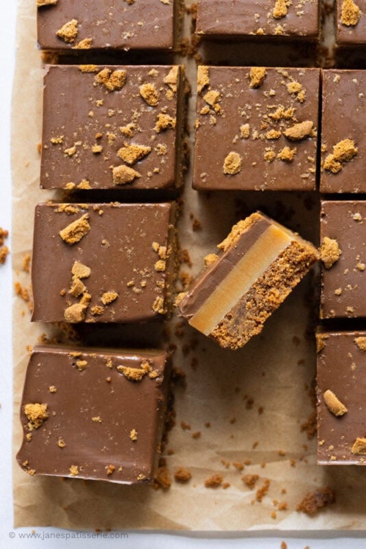 a cut tray bake of Biscoff Millionaires