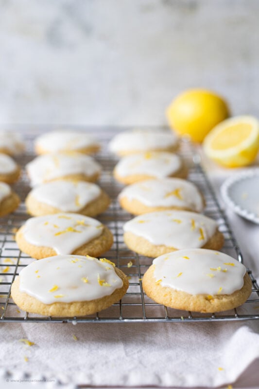 A cooling rack of glazed of lemon cookies