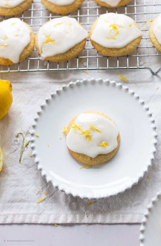 A glazed lemon cookie on a white plate