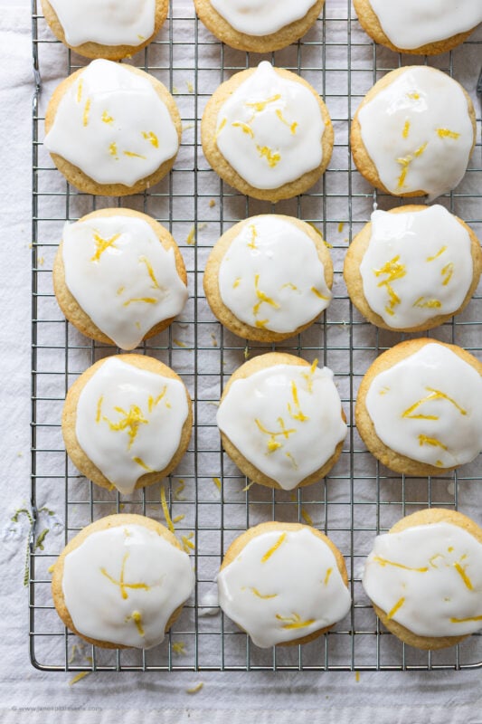 A large cooling rack of glazed lemon cookie