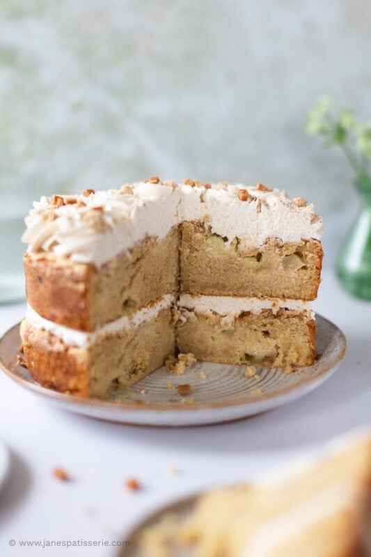 An apple crumble cake with one quarter slice missing.