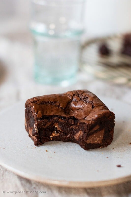 A bite removed from a slice of toblerone brownie