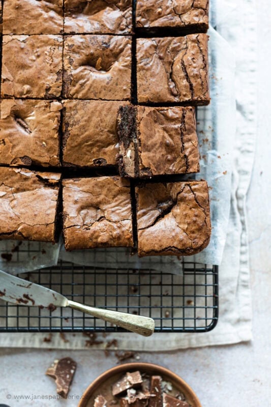 Toblerone Brownies cooling on a wire rack with a knife