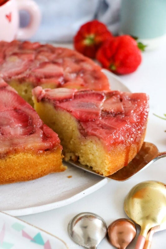 A slice being served of Strawberry Upside Down Cake.