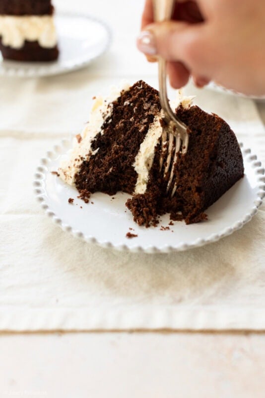 A fork digging into a slice of baileys cake