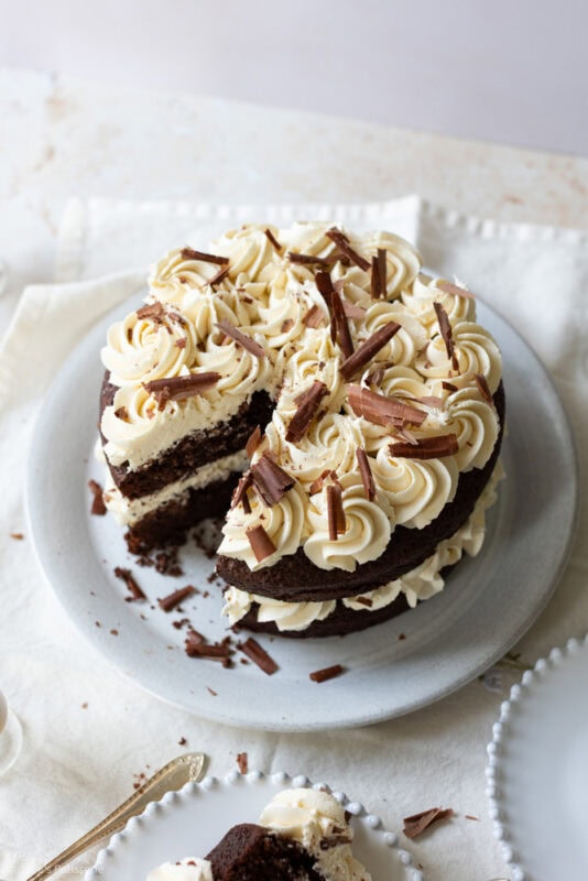 A slice missing from a whole baileys cake