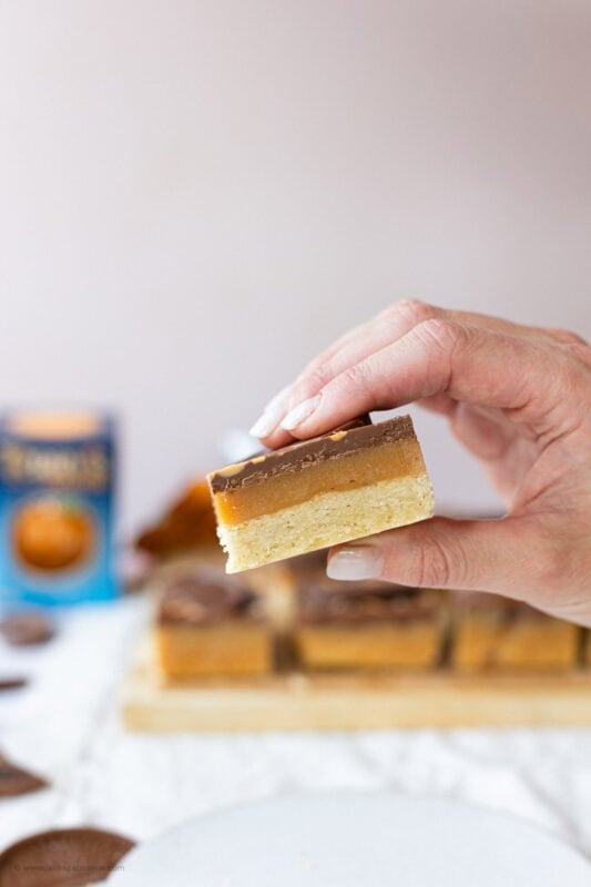 A hand holding a chocolate Orange Millionaires