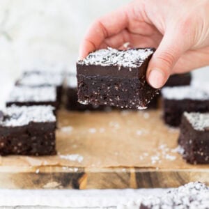 A hand holding a coconut brownie