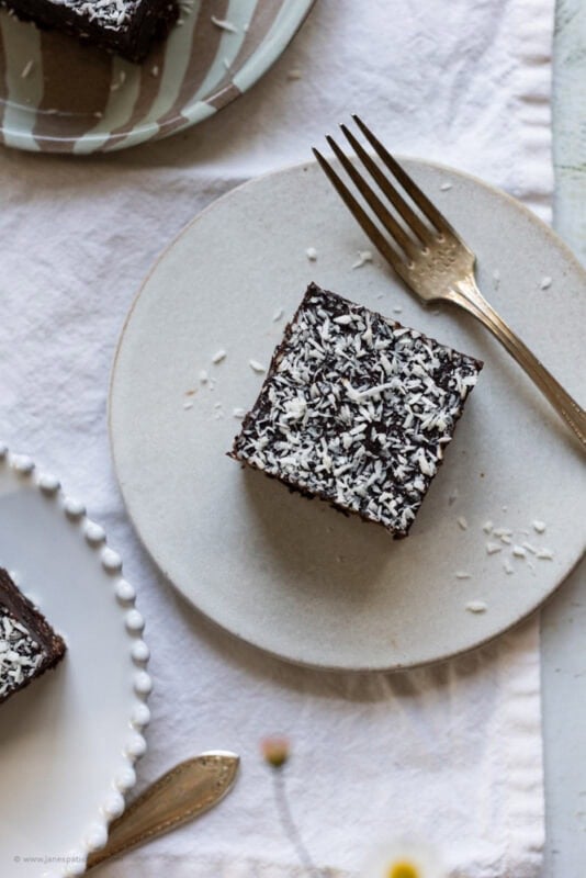 A coconut brownie on a plate with a fork