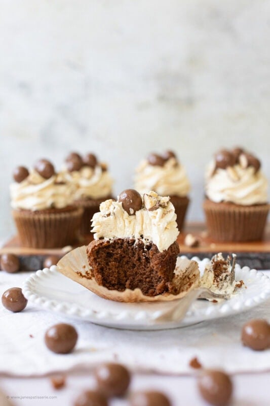 A bite taken from a malteser cupcake