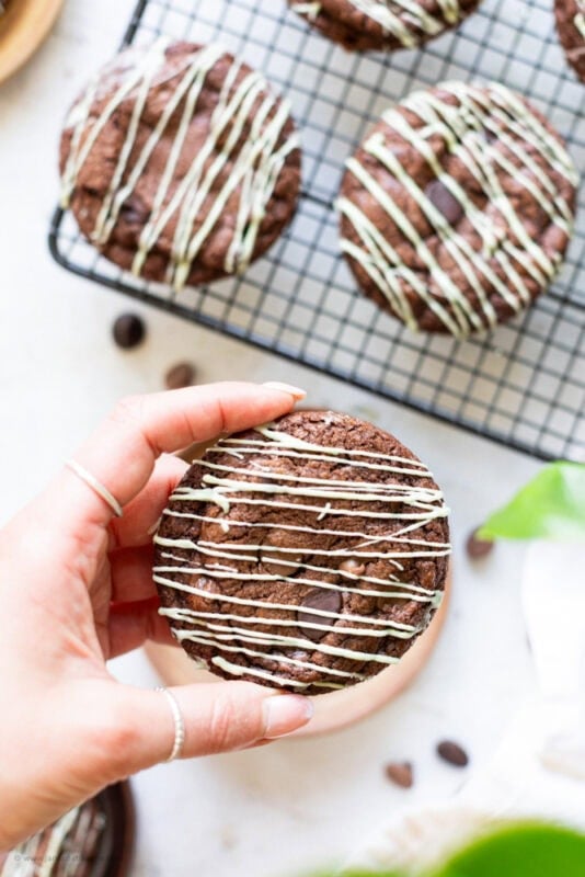 A hand holding a mint chocolate cookie