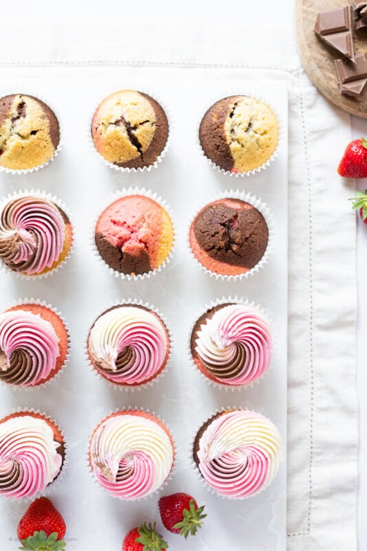 Rows of half decorated Neapolitan Cupcakes