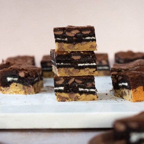 Three Slutty brownies stacked on each other on a worktop