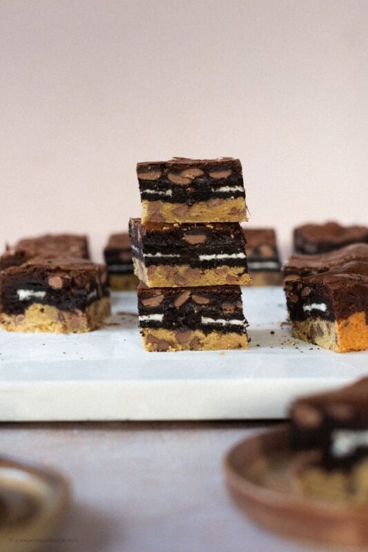 Three Slutty brownies stacked on each other on a worktop