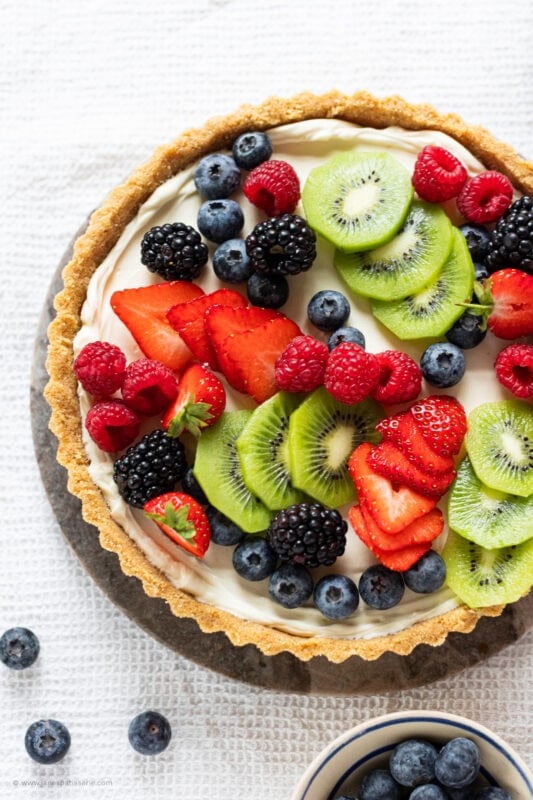 A whole Easy Fruit Tart with scattered fruit toppings