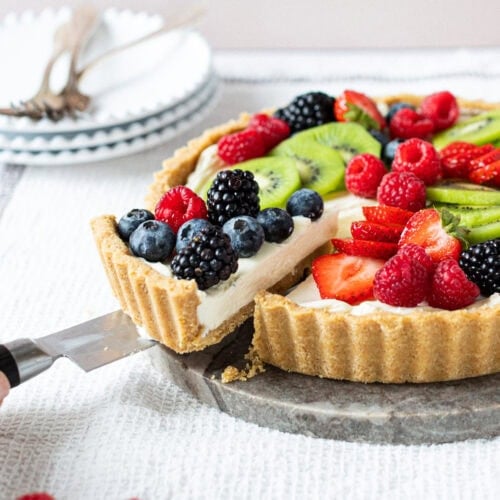 A slice being taken from a Easy Fruit Tart