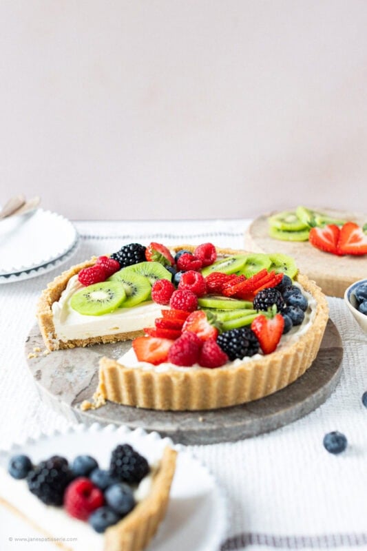 A Slice removed from the Easy Fruit Tart displaying the biscuit base