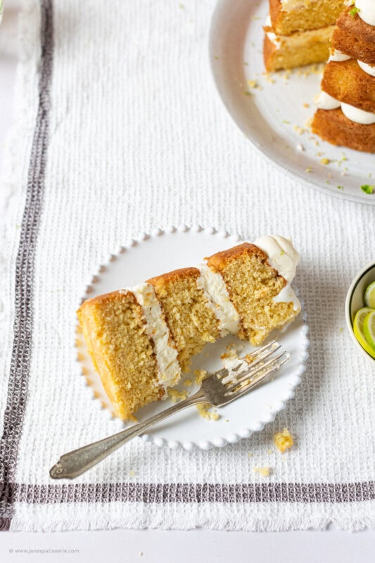 A slice of half eaten gin and tonic cake on a plate