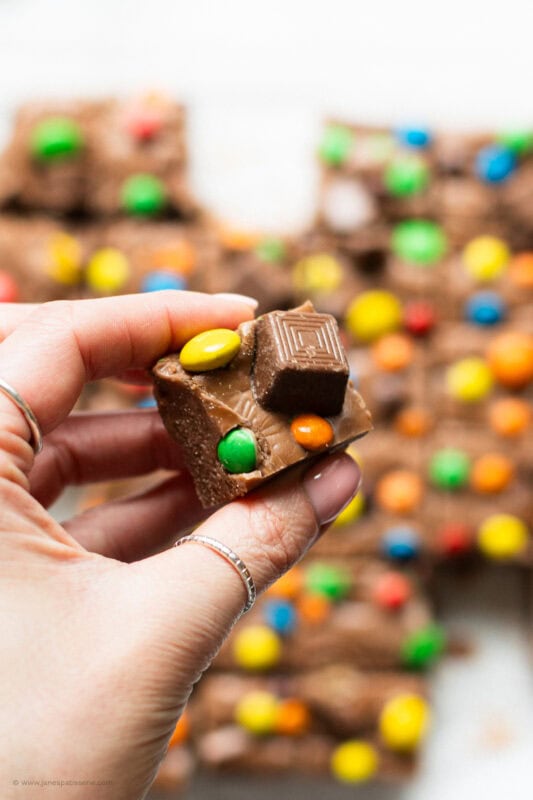 A hand holding a slice of microwave fudge