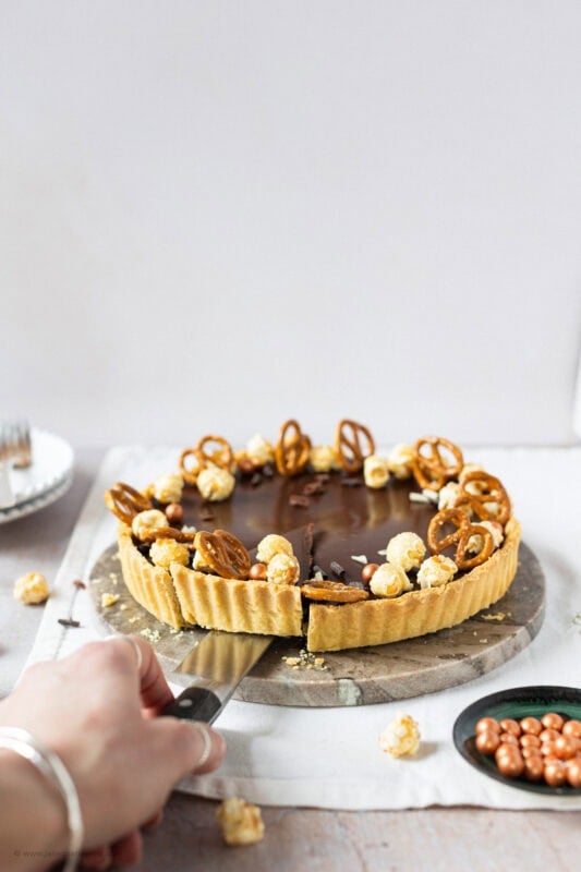 A slice being taken from a Salted Caramel Tart