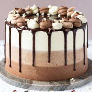 A whole triple chocolate cake on a table tray