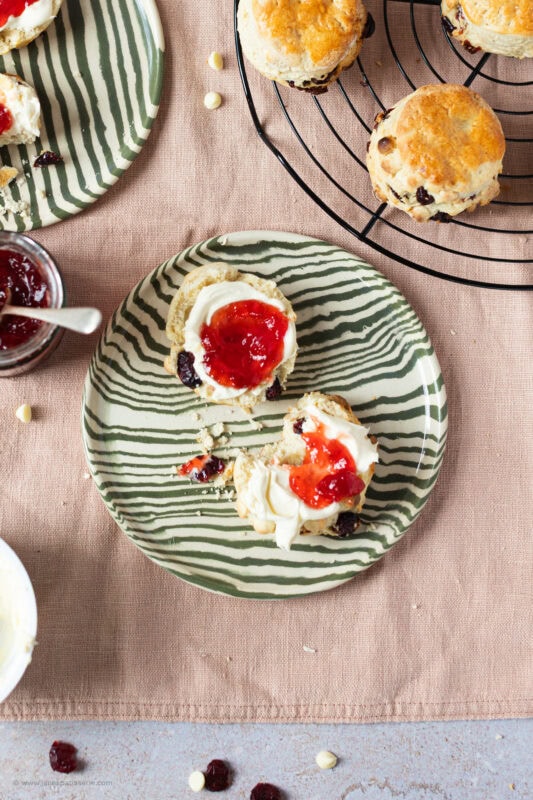 A white Chocolate and Cranberry Scone on a plate