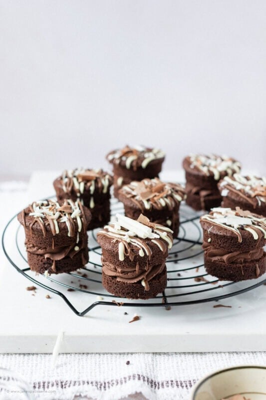 A finished batch of mini chocolate cakes on a cooling rack