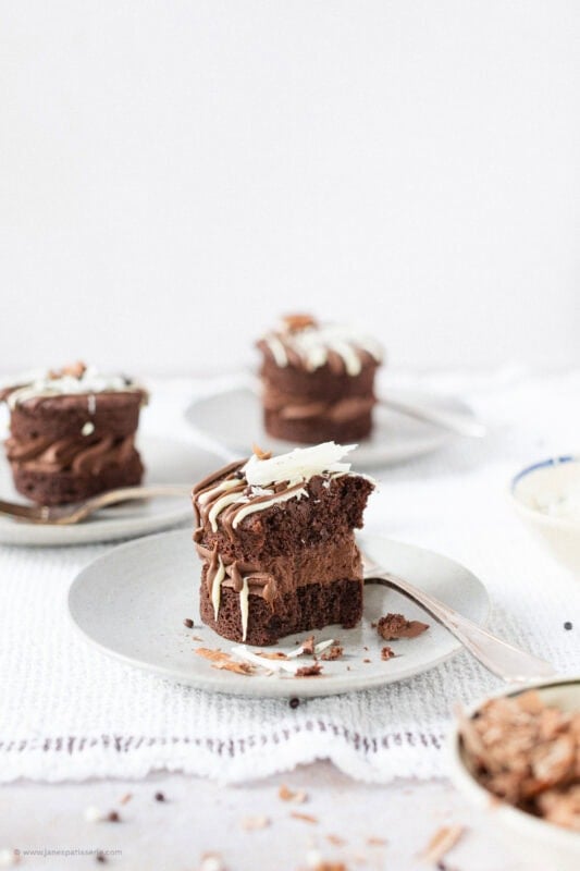 A bite missing from a Mini Chocolate Cake on a plate