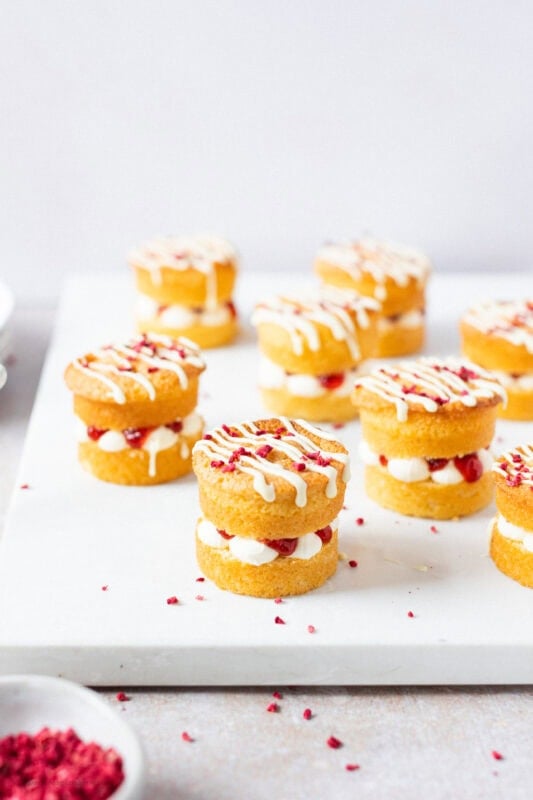 A tray of decorated mini Victoria sponge cakes