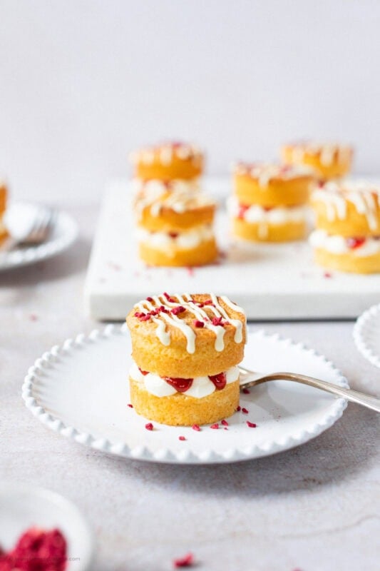 A single mini Victoria sponge cake on a plate with a fork