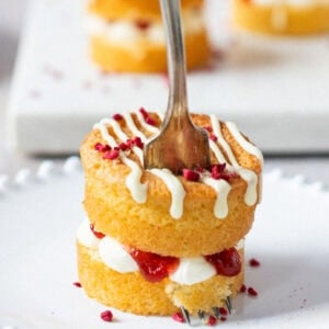 A fork placed in the top of a mini Victoria sponge cake