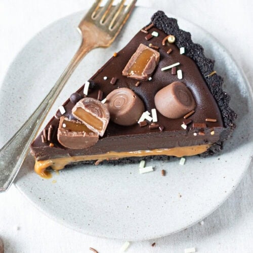 A slice of no-bake Rolo tart on a plate with a fork