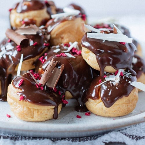 A finished batch of Profiteroles on a plate