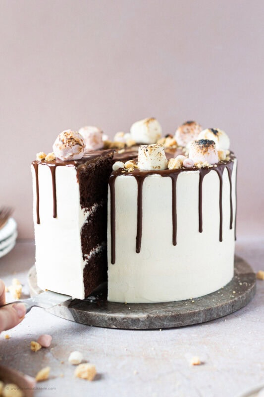 A slice being removed from a Smores Cake
