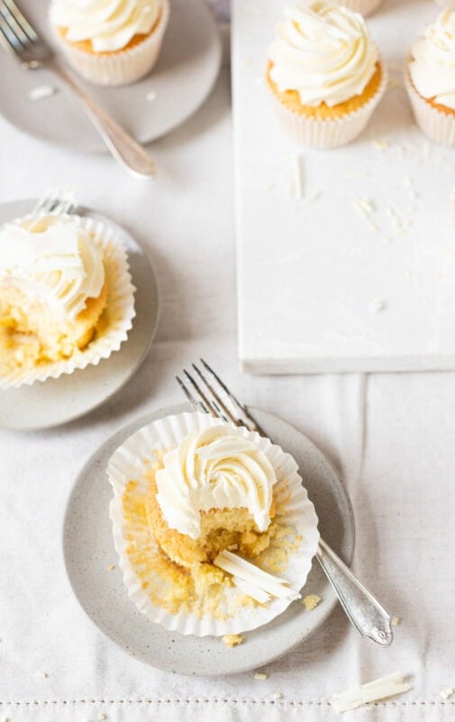 A bite missing from a White Chocolate Cupcake