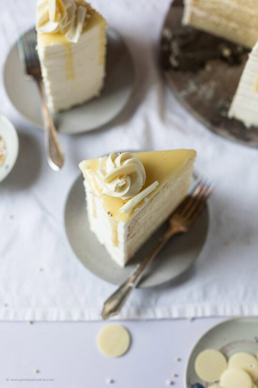 A top down shot of a slice of White chocolate drip cake