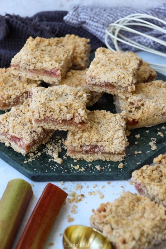 A collection of Rhubarb Crumble Bars on a chopping board