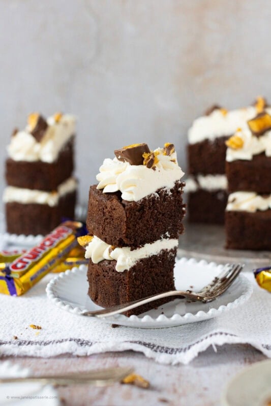 A bite missing from a slice of Honeycomb Crunchie Cake