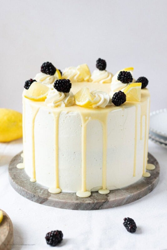 A full Lemon Elderflower Cake on a serving board