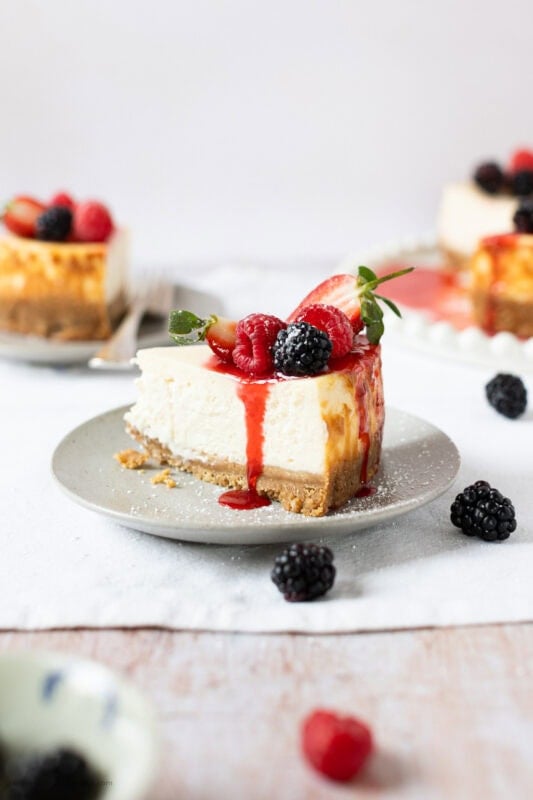 A slice of New York Cheesecake on a white plate