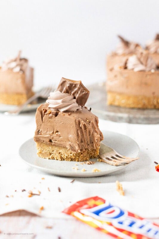 A bite taken from a slice of No-bake Daim Cheesecake