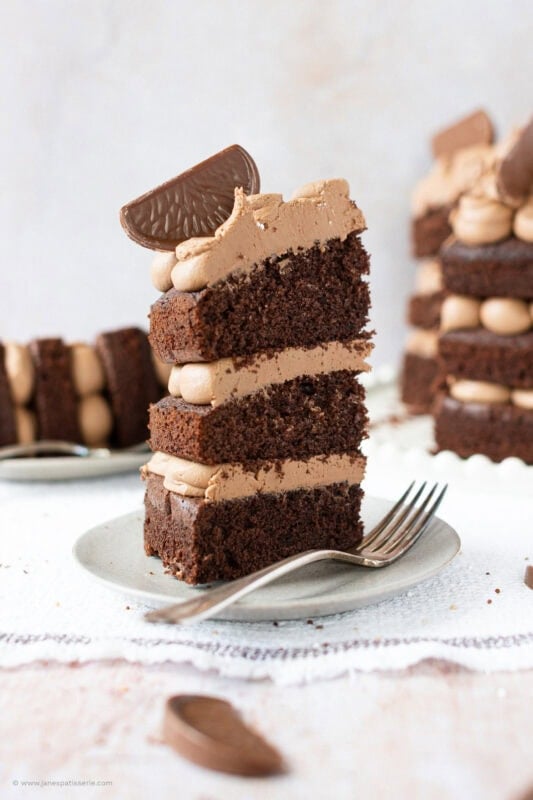 A slice of Terrys chocolate orange cake on a plate with a fork