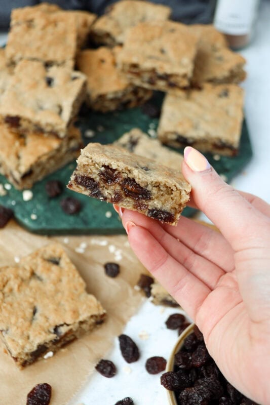 A hand holding a Oatmeal Raisin Bar